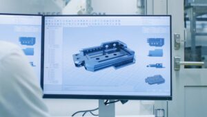 an engineer using CAD software to design custom molds and parts